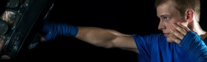 Ground Control Boxing - man punching a strike pad