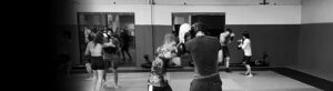 Multiple couples of people sparring with boxing gloves