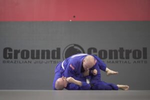 Two men grappling with each other on the ground in Brazilian jiu-jitsu