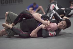 Two men grappling in a Brazilian jiu-jitsu class