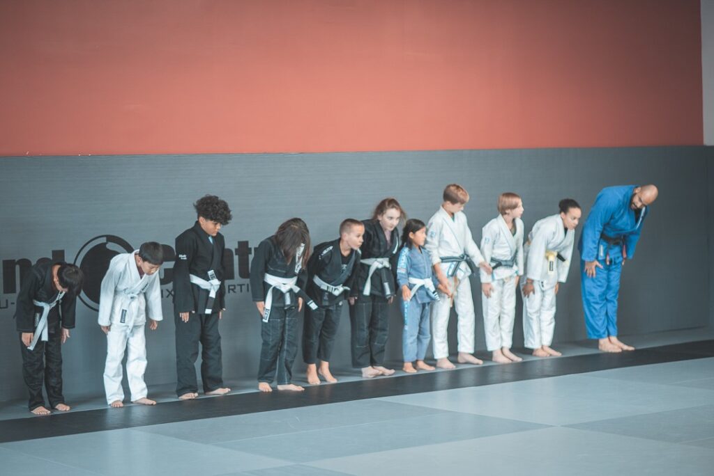 Line of kids bowing in a martial arts class