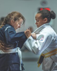 Two women grappling with each other in a women's martial arts class