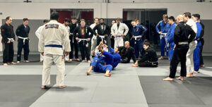 Students practicing martial arts techniques during a fitness class.